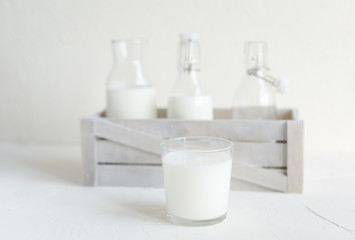 Milk in bottles on white background, kitchen