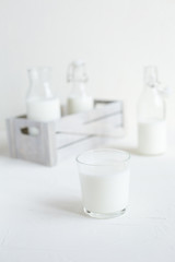 Milk in bottles on white background, kitchen