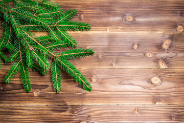 Christmas green pine fir spruce branch on wooden background