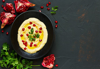 Traditional hummus, with pomegranate and cereal loaves. selective focus.