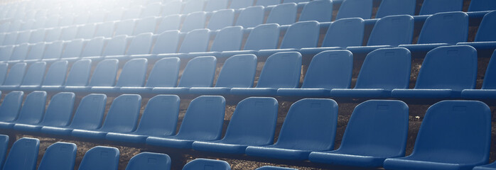 Fototapeta premium Dark blue rows of seats on the stadium banner