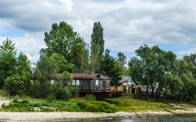 Old rusty fishing boat ship on the bank of the Pripyat River in the city of Petrikov. Belarus