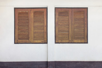 two wooden window on concrete wall