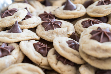 Selective focus on a pile of chocolate peanut butter kisses cookies made with brown sugar and chocolate