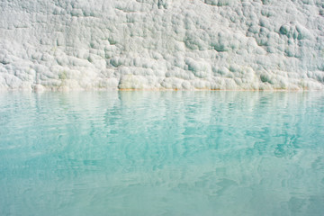 The enchanting pools of Pamukkale in Turkey. Hot springs and travertines, terraces of carbonate minerals left by the flowing water
