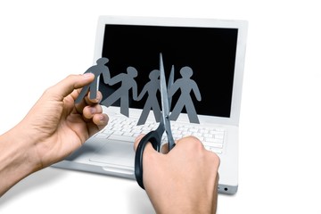 Closeup of Hands Cutting Paper People