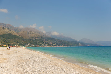 Fototapeta na wymiar View on the Borsh Beach in Albania. Stony beach on the Adriatic Sea. Mountain in the background.