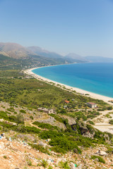 View on the Borsh Beach in Albania. Stony beach on the Adriatic Sea. Mountain in the background.
