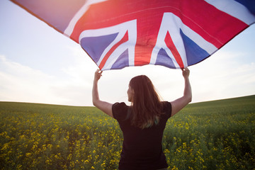 Girl with UK flag in green field
