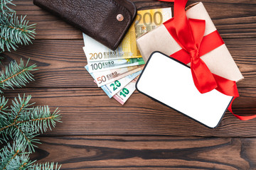 Wooden holiday background, Gift for loved ones. Space for text on the phone. Top view.