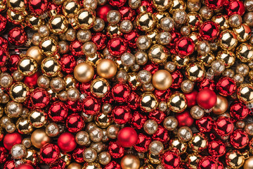 Christmas card. Wallpaper of red and gold baubles. Top view.