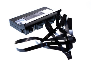 VHS video cassette with the tape unraveled isolated on a white background