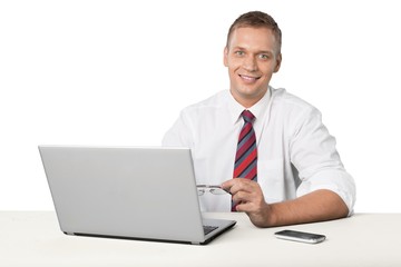 Fototapeta na wymiar Portrait of young man using laptop isolated on white background