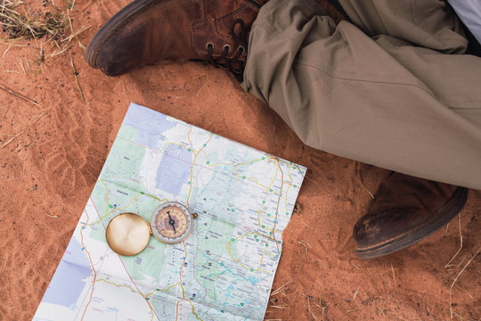 Crop legs near map and compass