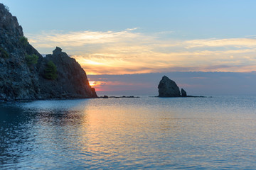 beautiful view of the rocks in the sea at dawn