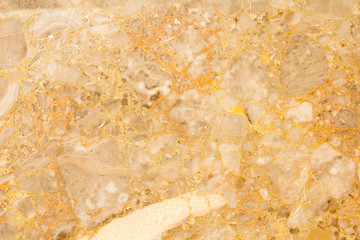 Golden colored marble texture abstract background pattern with high resolution.