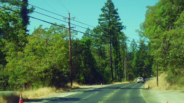 Multiple views of California road construction at different times of day with shadows, full sun and typical traffic management approaches.  Different vehicles used in road repair.