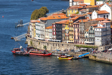 Fototapeta na wymiar Traditional boats with barrels of wine, on the Douro River in the Portuguese city of Porto.