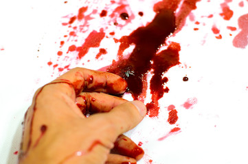 bloodied hand lies in a pool of blood