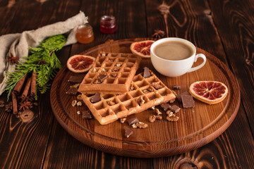 Tasty fresh Vienna wafers, jam and cup of coffee on a dark wooden background