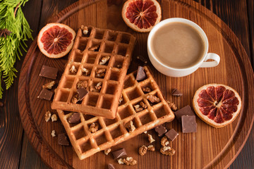 Tasty fresh Vienna wafers, jam and cup of coffee on a dark wooden background