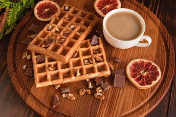 Tasty fresh Vienna wafers, jam and cup of coffee on a dark wooden background