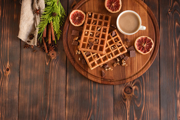 Tasty fresh Vienna wafers, jam and cup of coffee on a dark wooden background