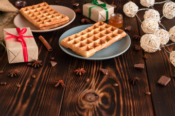 Tasty fresh Vienna wafers, jam and cup of coffee on a dark wooden background