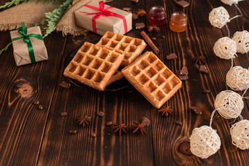 Tasty fresh Vienna wafers, jam and cup of coffee on a dark wooden background