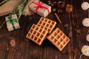 Tasty fresh Vienna wafers, jam and cup of coffee on a dark wooden background