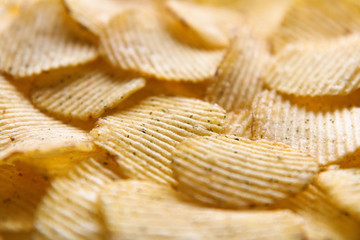 Close up Crispy potatoes chips isolated on white background top view. Food background. 
