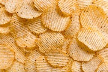 Close up Crispy potatoes chips isolated on white background top view. Food background. 