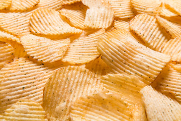 Close up Crispy potatoes chips isolated on white background top view. Food background. 
