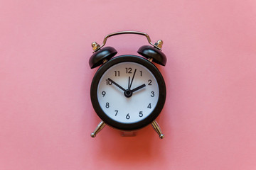Ringing twin bell vintage classic alarm clock Isolated on pink pastel colourful trendy background....