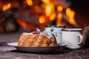 Christmas cake near fireplace