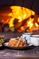 Christmas cake near fireplace