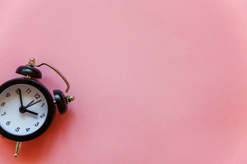 Ringing twin bell vintage classic alarm clock Isolated on pink pastel colourful trendy background....