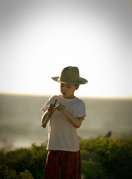 View of a small boy fixing his catapult.