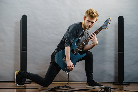 Young man playing electric guitar