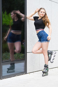 Young woman riding roller skates