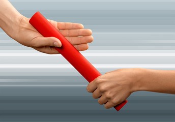 Close-up of relay baton being passed