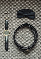 different accessories of a businessman for creating a style of a people lie on a wooden background