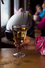 Girl holding a glass Cup of tea on the background of the window, outside the window the snow-capped mountains