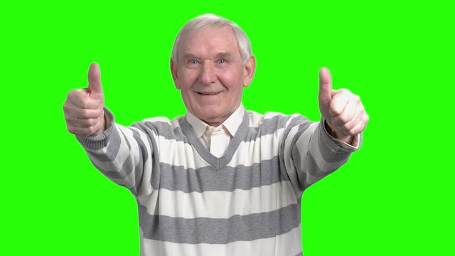 Front view of two thumps up from old man. Merry grandpa with thumbs up in green hromakey background.