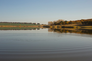 Autumn, landscape at dawn. Mirror lake with a reflection of nature. Morning silence.