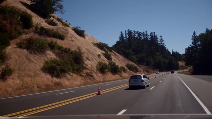 Multiple views of California road construction at different times of day with shadows, full sun and typical traffic management approaches.  Different vehicles used in road repair.