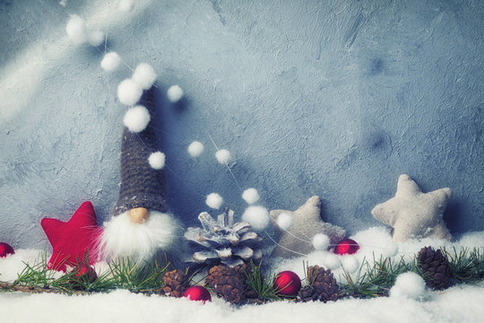 Cute Christmas gnome in abstract winter landscape