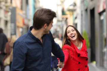 Fototapeta premium Couple running together in the street