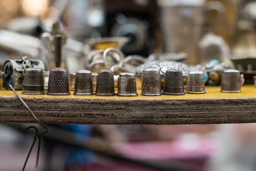 Vintage sewing thimbles close up, in San Telmo market, Buenos Aires, Argentina. 