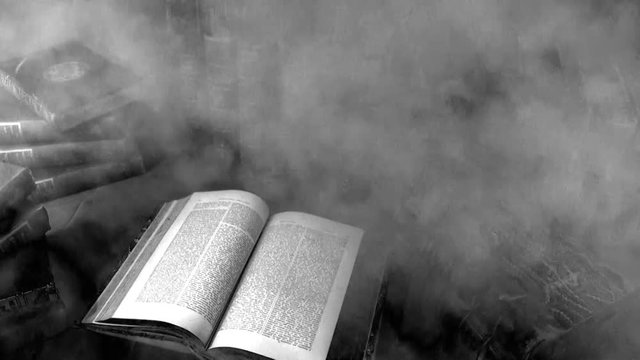 Haunted books - smoke / fog flowing across antique books